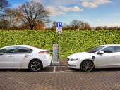 two hybrid electric cars are recharging