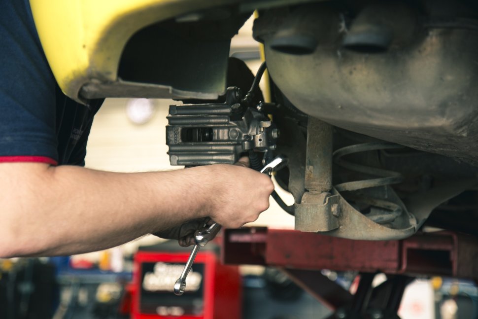 Mechanic is repairing his car in the garage